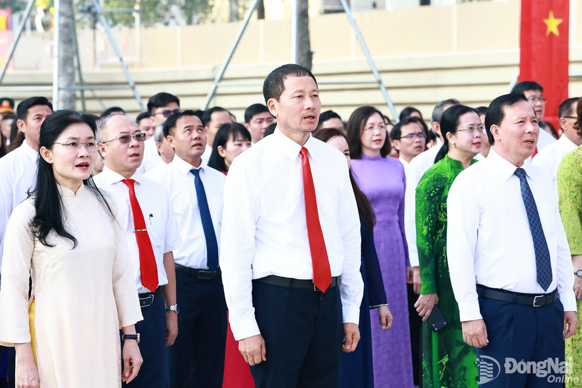 Delegates sing the national anthem at the flag-raising ceremony. Photo: Cong Nghia

