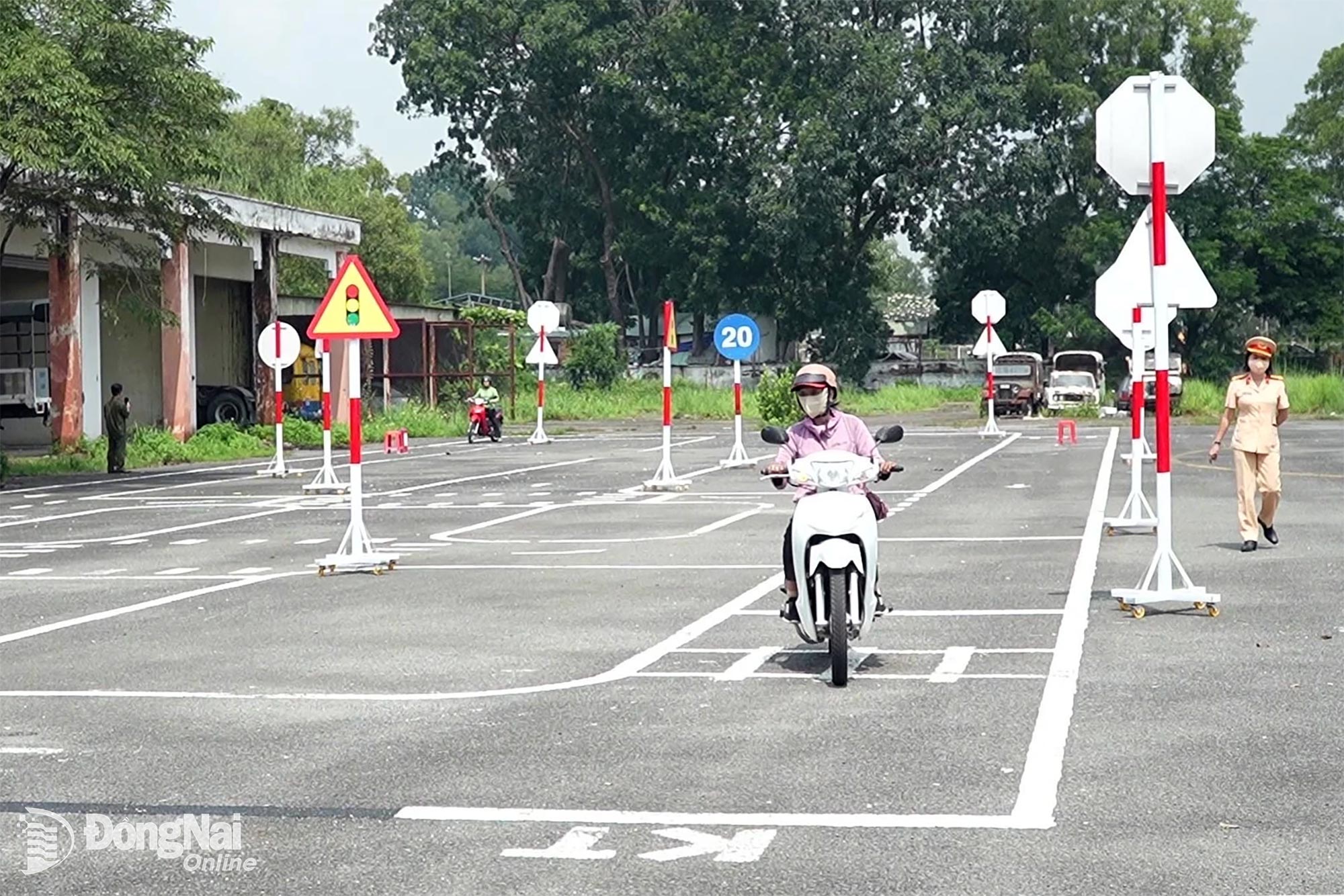 Các giáo viên cùng lực lượng chức năng địa phương tham gia phần hướng dẫn lái xe 11 tình huống giao thông thực tế tại phường Trấn Biên. Ảnh: Lê Duy