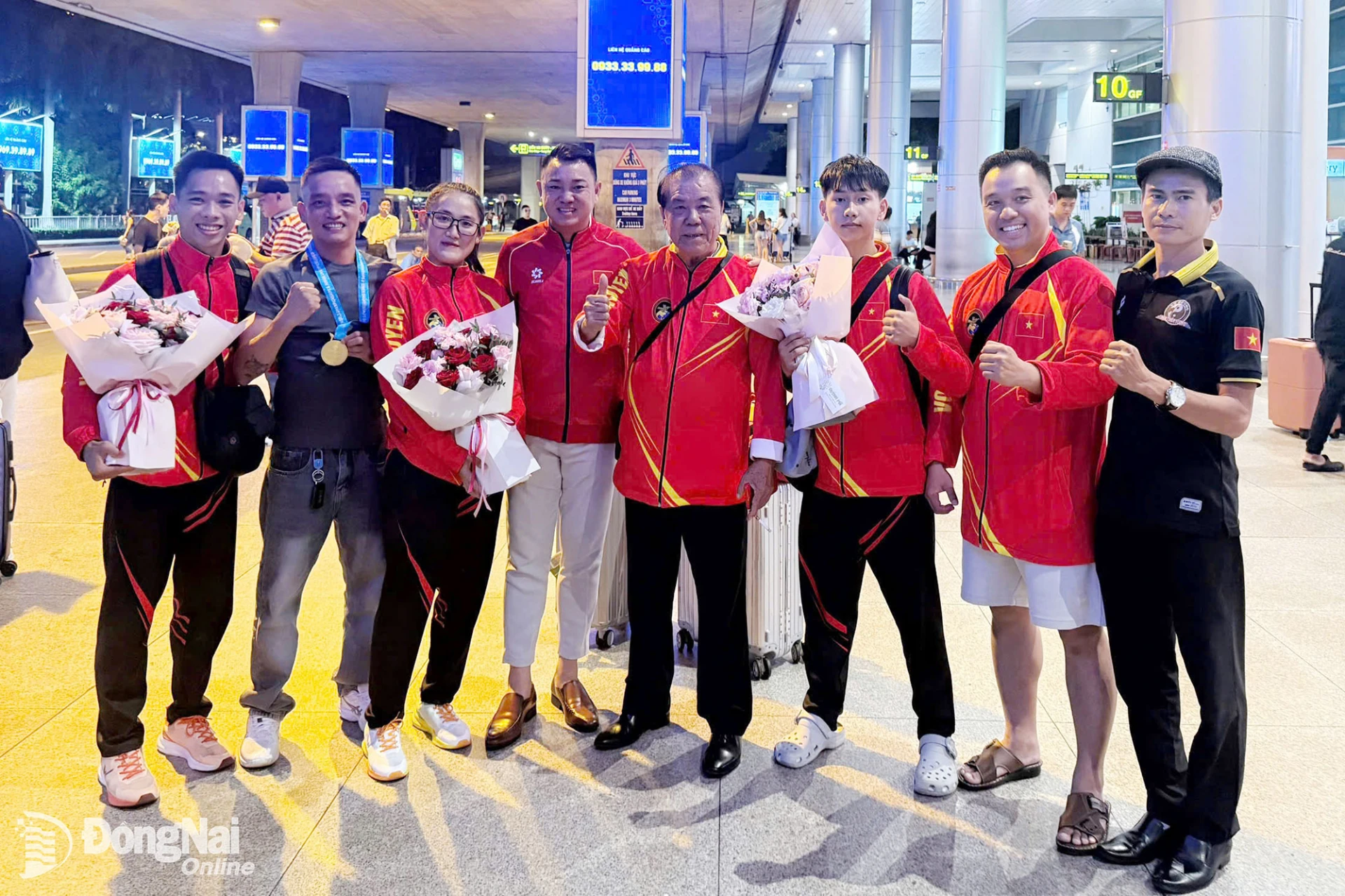 Ông Lê Trọng Anh, Phó Trưởng phòng Huấn luyện thể thao thành tích cao, Trung tâm Huấn luyện và Thi đấu thể thao thành phố Đồng Nai (thứ tư từ trái qua) cùng các huấn luyện viên chúc mừng đoàn vận động viên Đội tuyển Võ cổ truyền thành phố Đồng Nai tại Sân bay Tân Sơn Nhất. Ảnh: ĐVCC