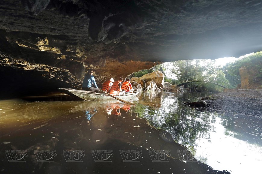 Tourists travel by boat to visit Hang But (Buddha Cave).