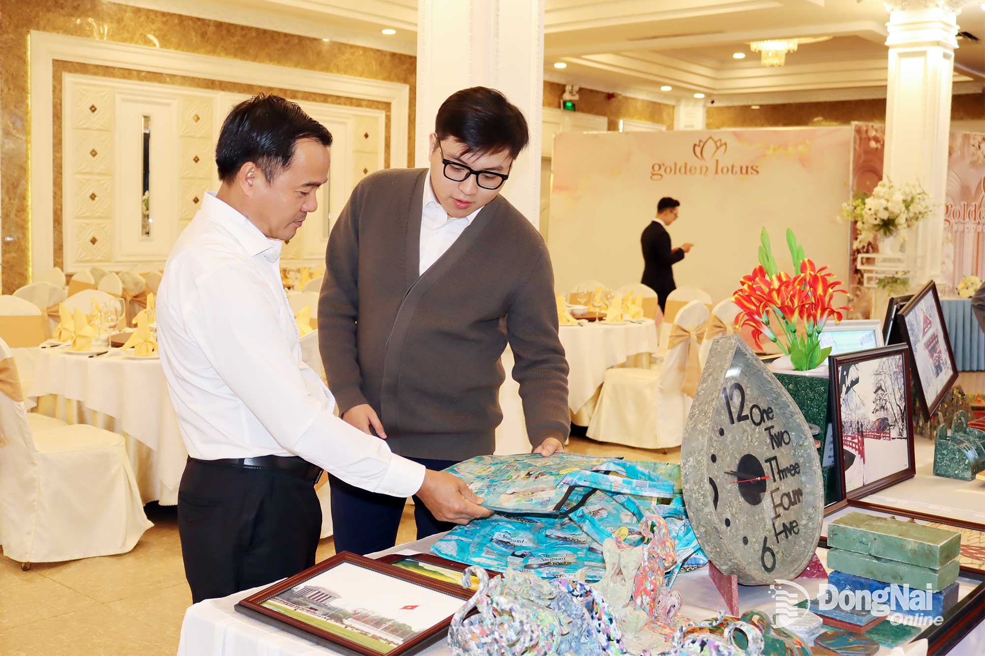 Delegates observe recycled products made from industrial waste by a Dong Nai enterprise, on display at the forum. Photo: Hoang Loc

