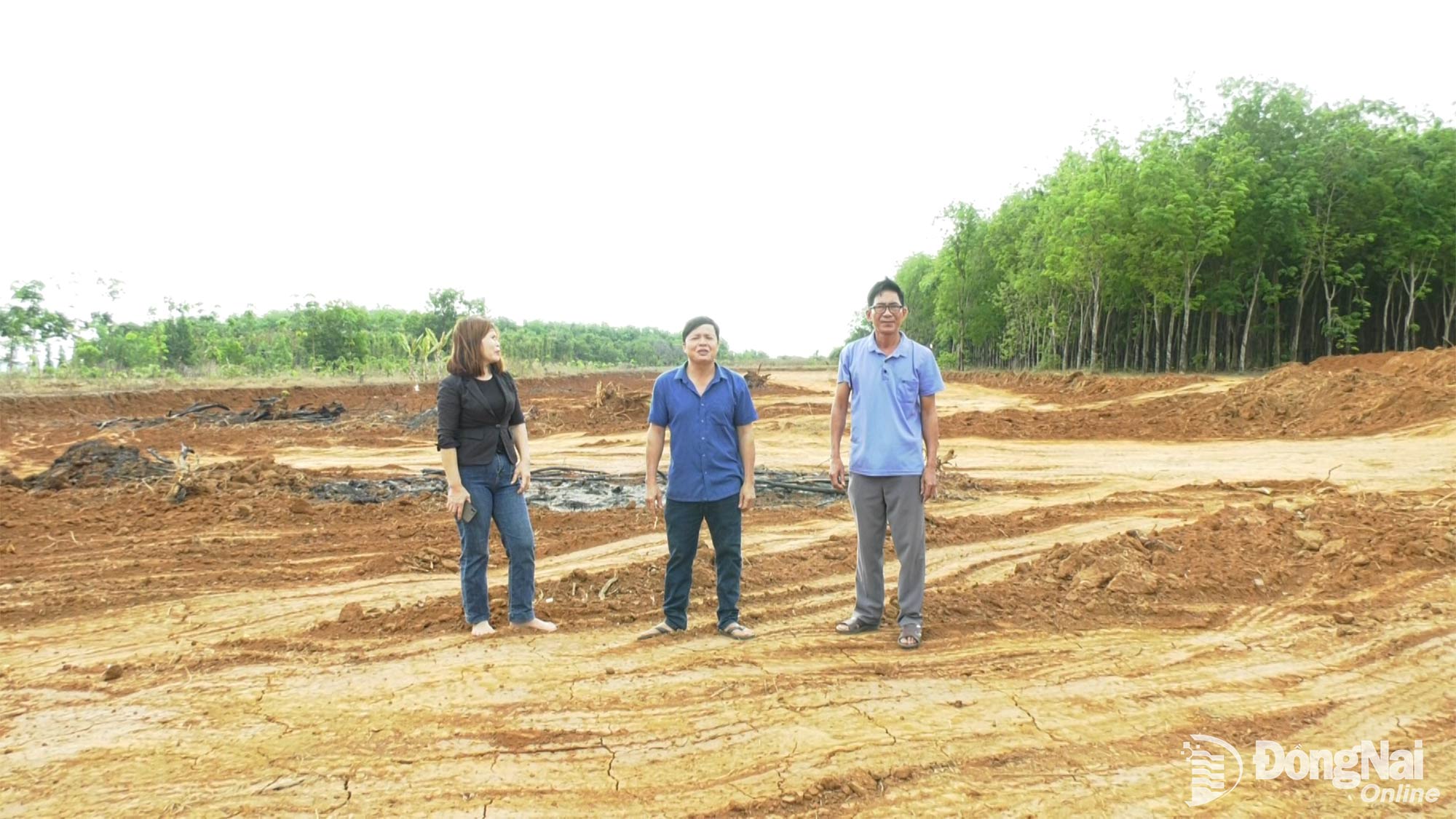 Ông La Văn Sanh (ở giữa) trên phần đất gia đình đã hiến để làm đường. Ảnh: Minh Hiền