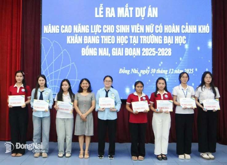 Representatives from Saigon Children’s Charity CIO present support to female students. Photo: Van Truyen