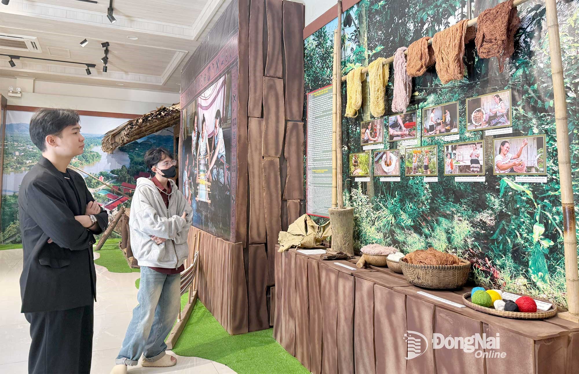 Visitors explore the traditional weaving process of Ma ethnic women on display at the museum. Photo: Nhat Ha