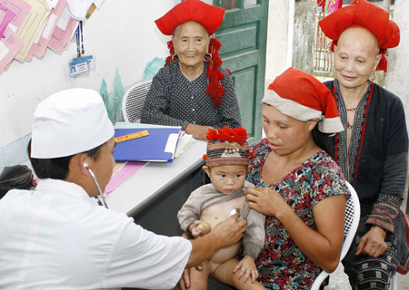 A doctor examines a child patient at a charity health program in the northern mountainous province of Lao Cai. Experts say Vietnam should champion breastfeeding to ensure future generations are taller and healthier.