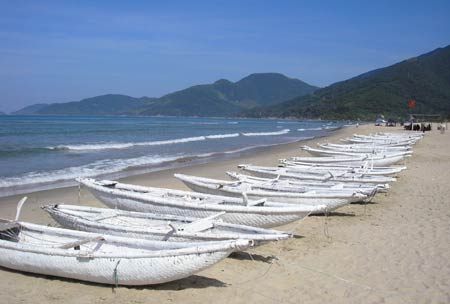 Lang Co Beach impresses tourists with white sands, clear blue waters, mountain ranges stretching to the seashore, and a peaceful fishing community