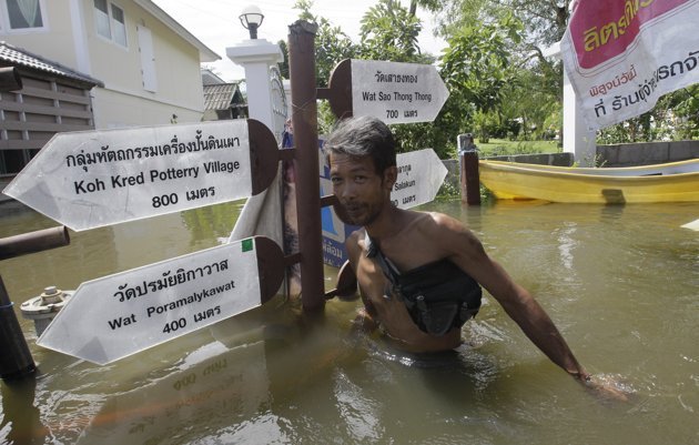 Một người dân lội qua nước lũ ở huyện Pak Kred, tỉnh Nonthaburi vào hôm 15-10.