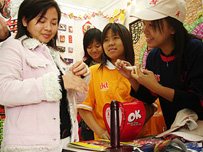 Visitors in a condom booth at an event on the theme of HIV/AIDS fight in Hanoi.