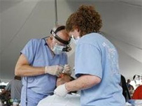 A man receives dental work during the Remote Area Medical (RAM) health clinic at the Wise County Fairgrounds in Wise, Virginia July 24, 2009.