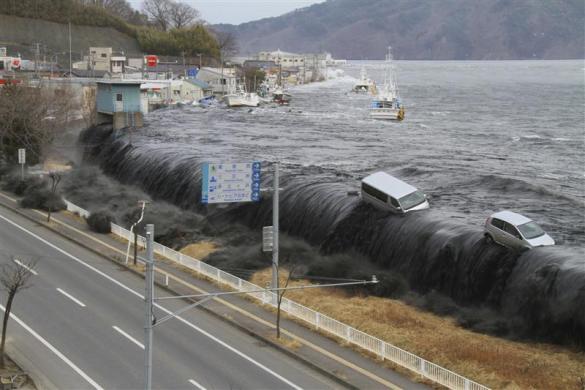 A wave from the tsunami crashes over a seawall in Miyako, Iwate Prefecture, March 11, 2011.