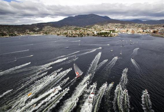 Australian supermaxi Wild Oats XI (C) approaches the finish line at Hobart during the annual Sydney to Hobart yacht race 