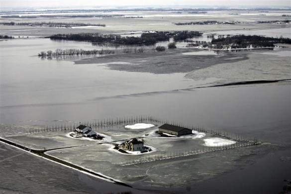 An aerial view shows snow, ice, and water from overland flooding cover the landscape south of Fargo, North Dakota