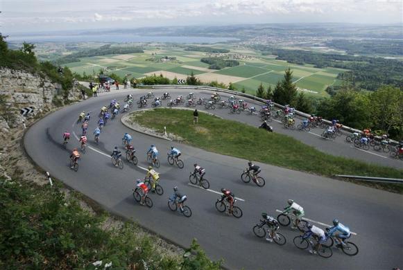 The pack of riders take a curve near Yverdon during the second stage of the Tour de Romandie cycling race in Lucens, Switzerland