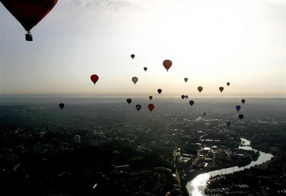 Balloons fly across the Bristol city centre during the 2006 Bristol International Balloon Fiesta in southwest England