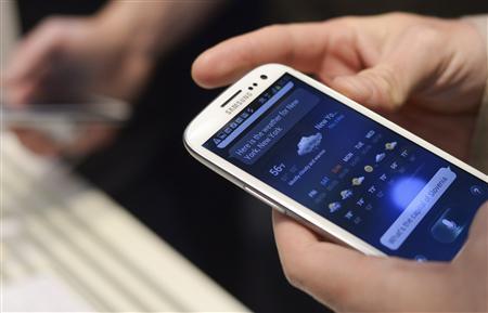 1 of 2. A man uses Samsung Electronics' new Samsung Galaxy SIII smartphone during its launch at The Earls Court Exhibition Centre in London May 3, 2012. 