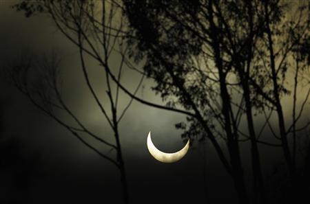 The moon passes between the sun and the earth as viewed through coastal fog rolling in from the ocean in Encinitas, California May 20, 2012. The sun and moon aligned over the earth in a rare More... Credit: 