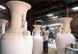 A worker puts the finishing touches to a piece before it goes into a kiln in Dong Tam Ceramic Factory in the southern province of Dong Nai's Bien Hoa City