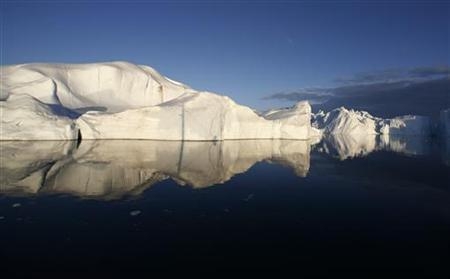 cebergs are reflected in the calm waters at the mouth of the Jakobshavn ice fjord near Ilulissat in Greenland in this photo taken May 15, 2007. 