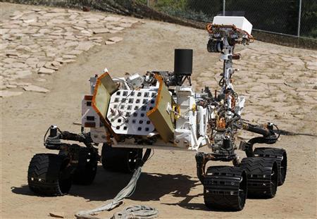 An engineering model of NASA's Curiosity Mars rover is seen from the rear in a sandy, Mars-like environment named the Mars Yard at NASA's Jet Propulsion Laboratory in Pasadena, California July 25, 2012