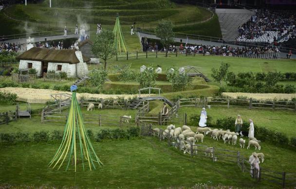 Actors stand during a scene showing a pre industrial rural England during the opening ceremony of the London 2012 Olympic Games.