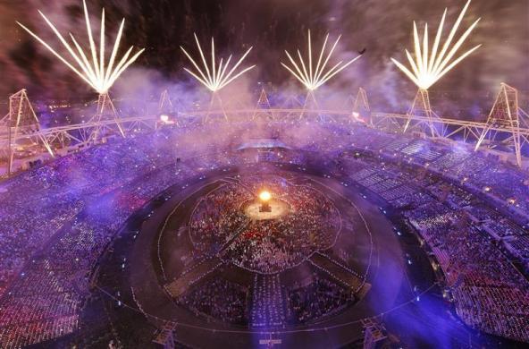 Fireworks explode over the lit Olympic Cauldron during the opening ceremony of the London 2012 Olympic Games.