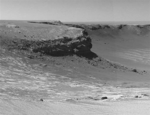 Rocky cliffs in the foreground named "Cape Verde" are seen in this image taken by Mars Exploration rover in 2006. 