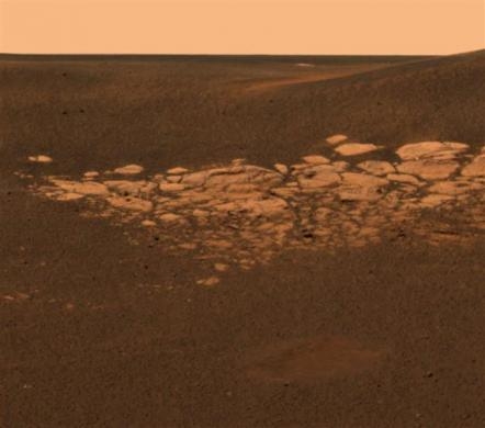 A high-resolution image, using data from the NASA Mars Exploration Rover Opportunity's panoramic camera's near-infrared, blue and green filters combined to create an approximate true-color image, highlights the puzzling rock outcropping that lies to the northwest of the rover, January 28, 2004. 