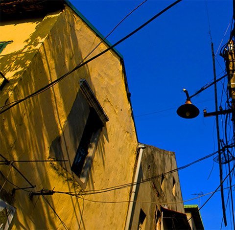 The late sunshine falls on old houses.