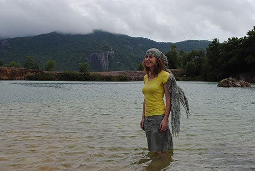 Frances Walsh, a tourist from Ireland, poses at the lake on Ta Pa Mountain’s peak
