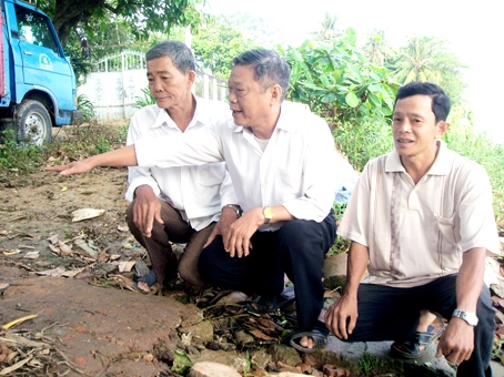 Ông Nguyễn Văn Tài (giữa) bên khúc sông, nơi thường có xác các nạn nhân xấu số trôi dạt vào.