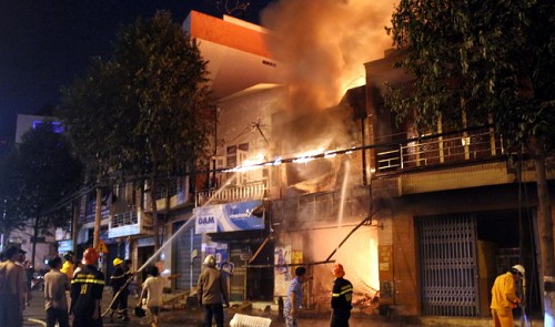 Firefighters battle a fire at a motorbike saddle cover shop in southern Vietnams Dong Nai Province on December 22, 2013.