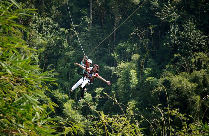 Tourists zipline at Madagui Forest City in Lam Dong Province 