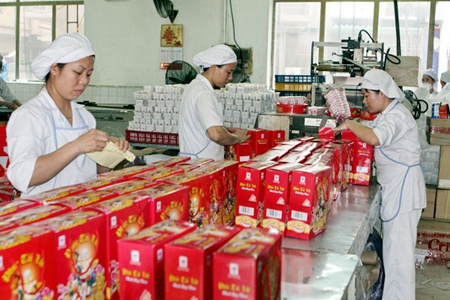 Workers of the Hai Ha-Kotobuki Company pack confectionery products for the upcoming Tet holiday. Made-in-Viet Nam products accounts for 90 per cent of the domestic market.