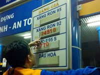 An employee of a gasoline station in Ho Chi Minh City changes listed prices
