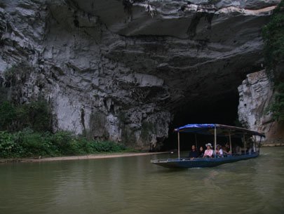 A tourist boat cruises along the Nang River at the gate of Puong Cave in Bac Kan Province 