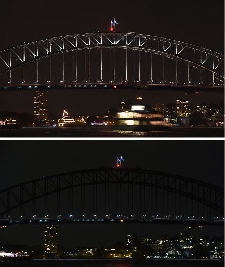 The Sydney Harbour Bridge is plunged into darkness for the Earth Hour environmental campaign, among the first landmarks around the world to dim their lights for the event, on March 29, 2014.