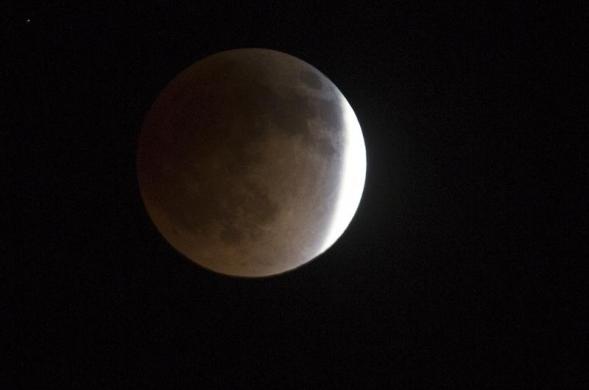 The moon is shown in eclipse over Salt Lake City, Utah, late April 14, 2014.  