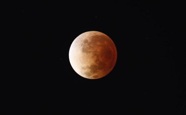 The moon is seen as it begins a total lunar eclipse over Buenos Aires April 15, 2014.  