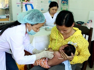 Giving a measles shot to children.