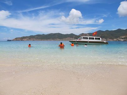 Tourists are seen at a beach in the bay 