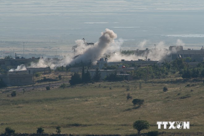 Khói bốc lên trong vụ xung đột giữa quân đội Syria và lực lượng đối lập tại làng Qahtaniya, biên giới giữa Israel và Syria trên Cao nguyên Golan, ngày 12/5. (Nguồn: THX/TTXVN)