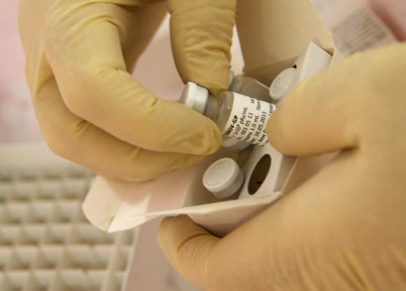 Scientists at the National Microbiology Lab in Winnipeg, Manitoba, prepare an experimental Ebola vaccine for shipment to the World Health Organization (WHO) in Geneva in this undated handout picture released October 18, 2014.