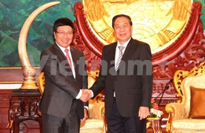 Lao Deputy Prime Minister and Foreign Minister Thonglun Sisulith receives his Vietnamese counterpart Pham Binh Minh