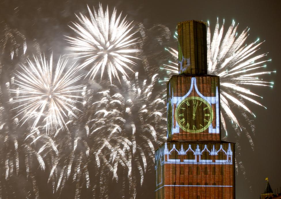 2 Fireworks light the sky over the Kremlin's Spasskaya (Saviour) Tower, covered by scaffolding, during celebrations of New Year's Day in Red Square in Moscow, Russia.