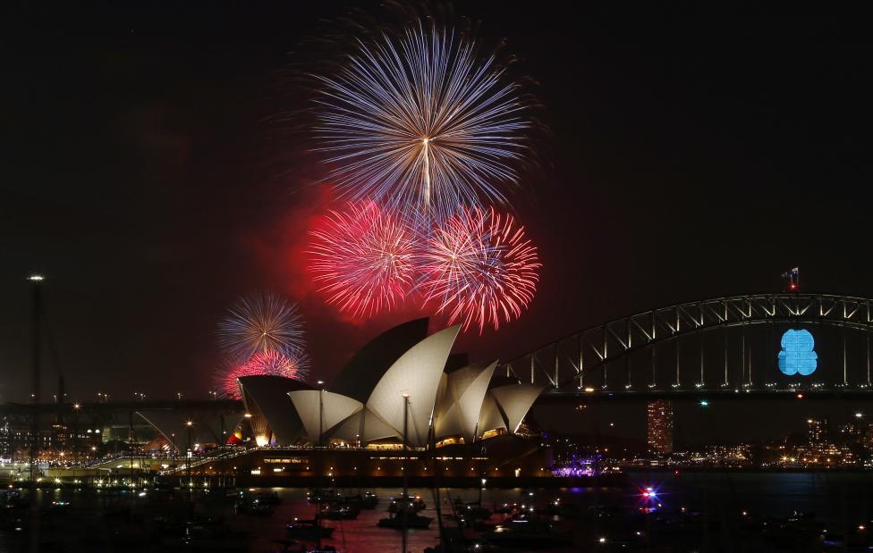 8 Fireworks light up the Sydney Opera House and Harbour Bridge during an early light show before the midnight New Year fireworks, December 31, 2014. 