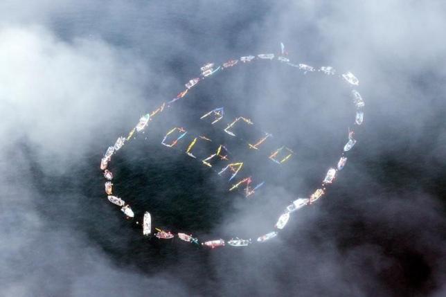  Commercial fishermen and other mariners form the words ''Acid Ocean'' during an event held to spread the message of saving the oceans from acidification caused by fossil fuel emissions, in Homer, Alaska, in this file photo taken on September 6, 2009. 