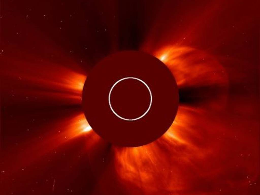 A giant cloud of solar particles, a coronal mass ejection, explodes off the sun, lower right, captured by the European Space Agency and NASA's Solar and Heliospheric Observatory