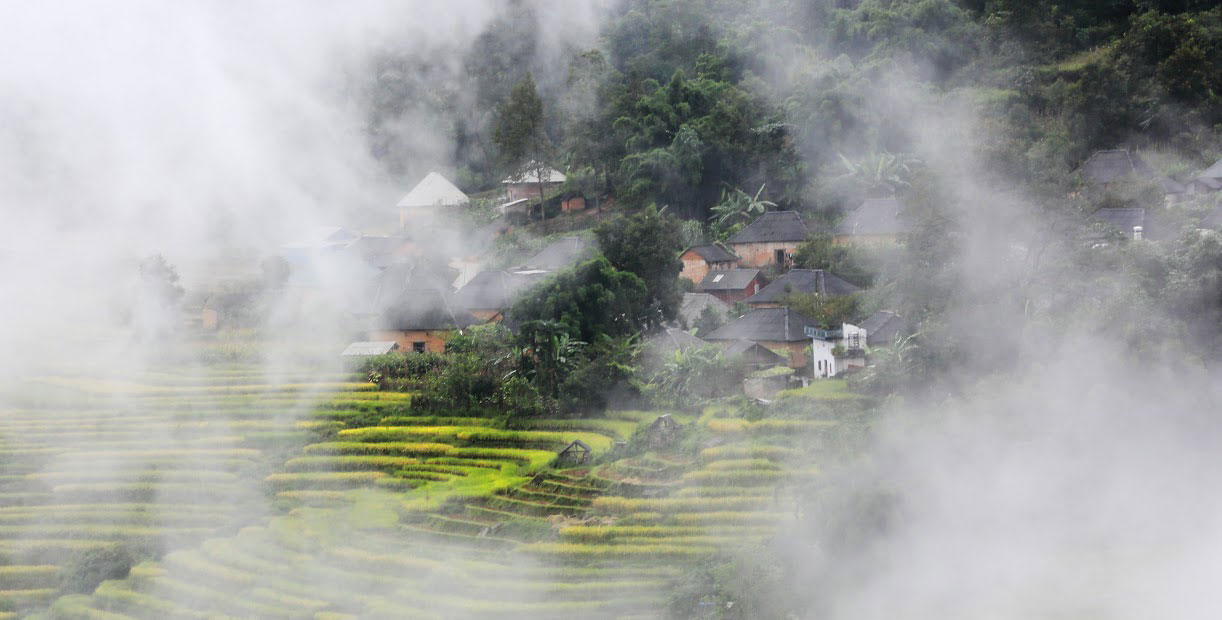 Clouds embrace hamlets, skimming terrace fields