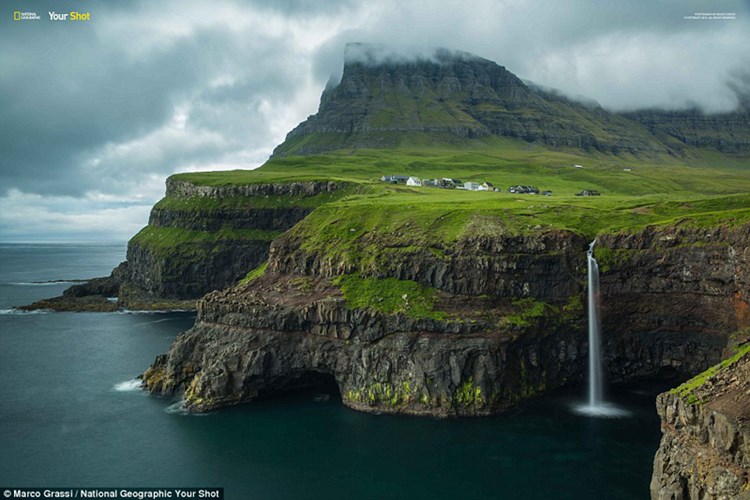  Fog enhances the fantasy effect of this cliffside location with waterfalls spilling into the craggy, dark seas 