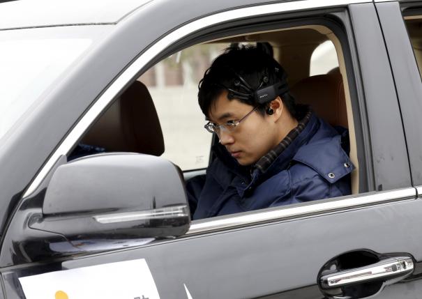  Researcher Zhang Zhao wearing a brain signal-reading equipment prepares to move a car with his brain wave, during a demonstration at Nankai University in Tianjin, China, November 17, 2015. Reuters/Kim Kyung-Hoon